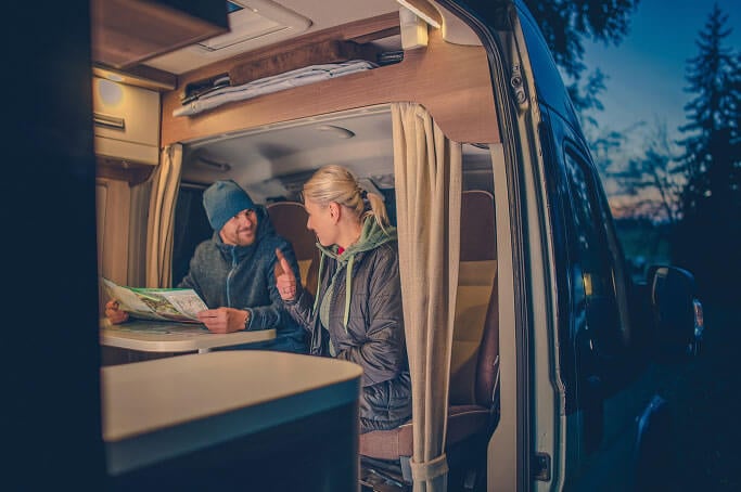 Man and Woman Sitting in RV